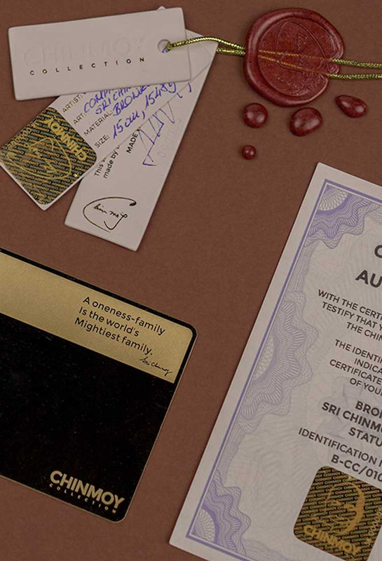 Chinmoy Collection handmade Certificate holder and certificate. Gold warranty card with wax stamp on the table