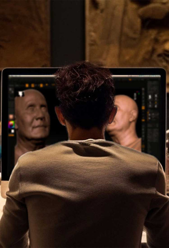 The digital sculptor works on the bronze statues in his studio, sitting in front of a 27-inch iMac monitor where he is designing work of art digital version.